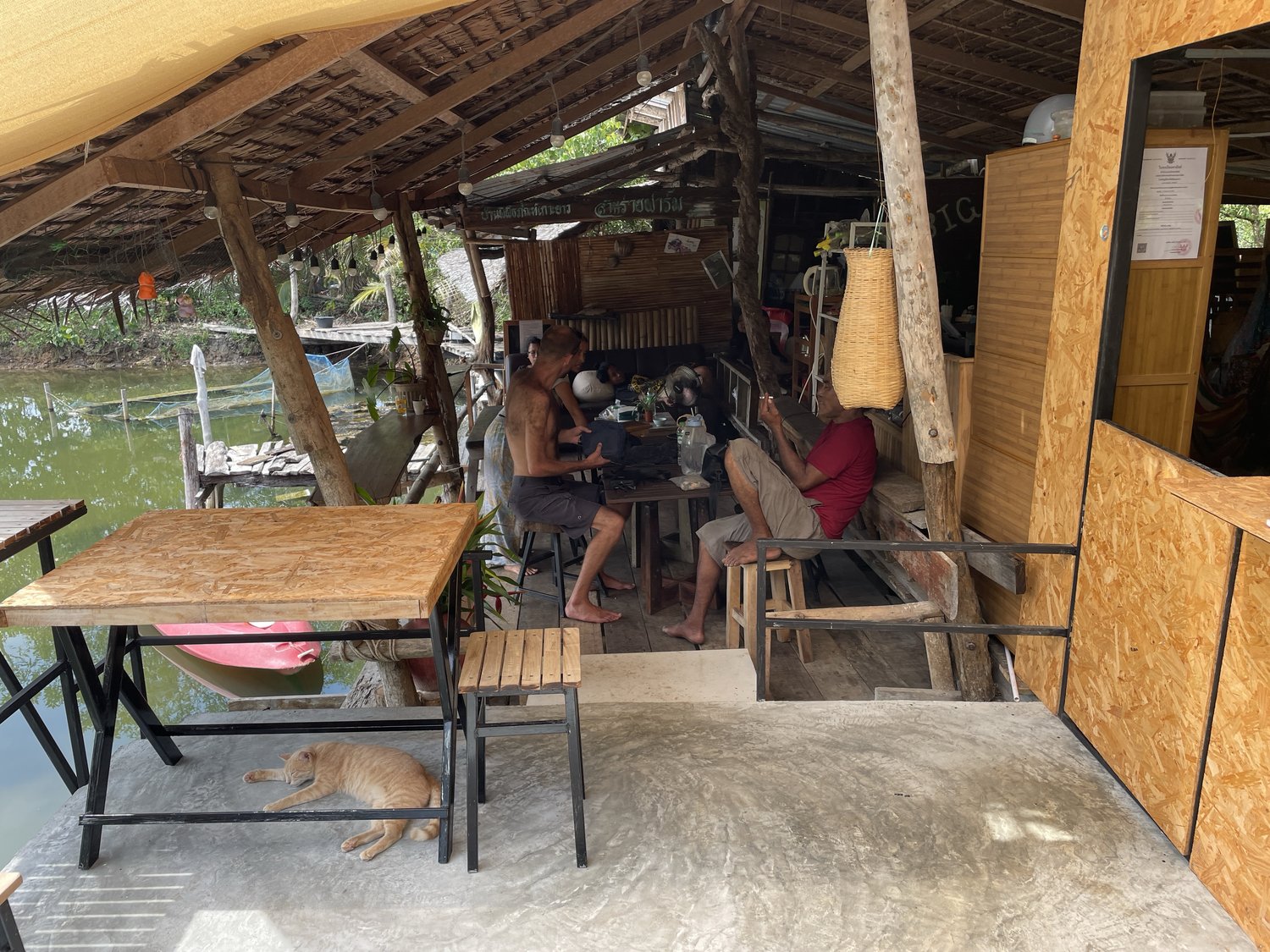 Guests relaxing in the open-air common area over the water